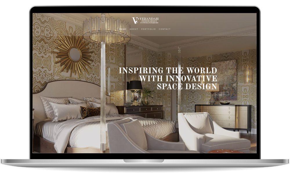 verandah Laptop displaying a website homepage with a luxurious bedroom interior, featuring the text "Inspiring the world with innovative space design" in the center.